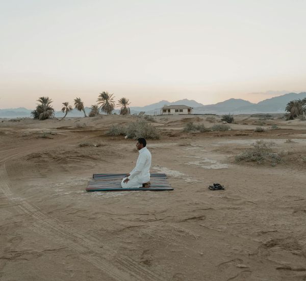 Person meditating outdoors at sunrise, looking peaceful and energized.